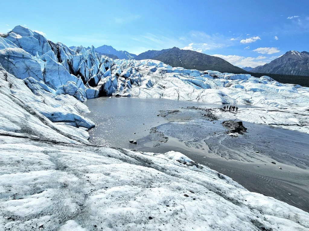 Cruising with Danny and Peter, Holland America Line, Westerdam, Anchorage, Alaska, United States | Experience the Matanuska Glacier Tour with stunning views of the glacier’s vast ice formations, an all-terrain vehicle ride, thrilling glacier hikes, and the unique refreshment of drinking crystal-clear glacial water, all complemented by stops at charming local eateries offering authentic Alaskan cuisine.