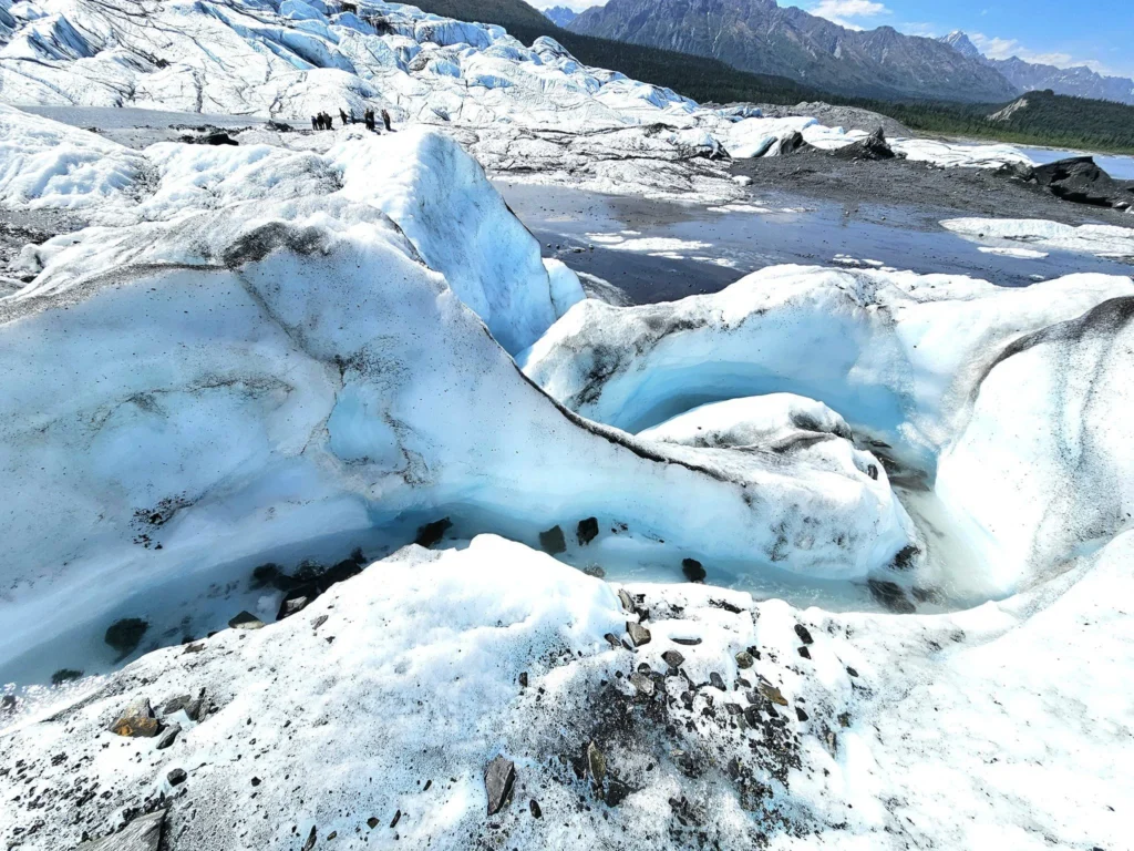 Cruising with Danny and Peter, Holland America Line, Westerdam, Anchorage, Alaska, United States | Experience the Matanuska Glacier Tour with stunning views of the glacier’s vast ice formations, an all-terrain vehicle ride, thrilling glacier hikes, and the unique refreshment of drinking crystal-clear glacial water, all complemented by stops at charming local eateries offering authentic Alaskan cuisine.