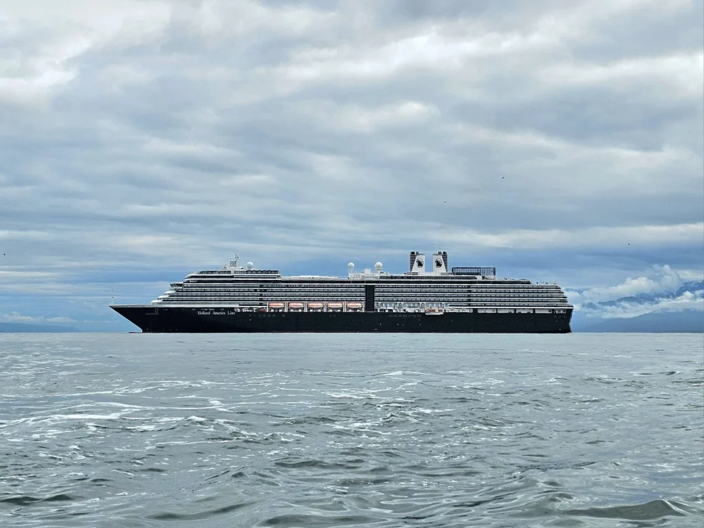 Cruising with Danny and Peter, Holland America Line, Westerdam, Spit (Homer), Alaska, United States | Boat on a morning water tour near Spit with Alaska Water Taxi & Charter, showing seabirds in flight, playful seals in Peterson Bay, sea otters in Cook Inlet, and guests enjoying The Orange Party on the Westerdam. Highlights include scenic boardwalk in Spit and a delicious Alaska seafood boil at Lido Market.