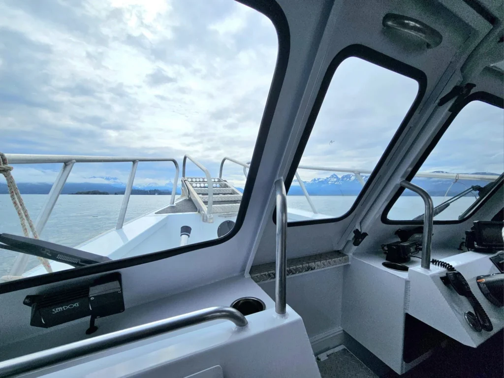 Cruising with Danny and Peter, Holland America Line, Westerdam, Spit (Homer), Alaska, United States | Boat on a morning water tour near Spit with Alaska Water Taxi & Charter, showing seabirds in flight, playful seals in Peterson Bay, sea otters in Cook Inlet, and guests enjoying The Orange Party on the Westerdam. Highlights include scenic boardwalk in Spit and a delicious Alaska seafood boil at Lido Market.