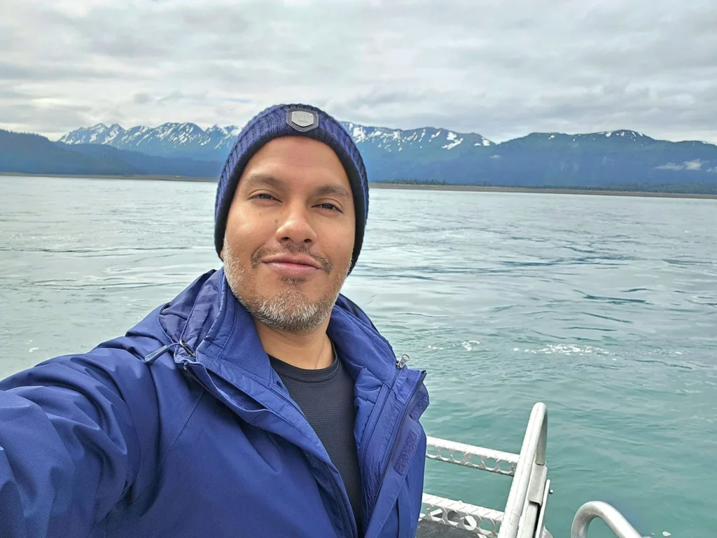 Cruising with Danny and Peter, Holland America Line, Westerdam, Spit (Homer), Alaska, United States | Boat on a morning water tour near Spit with Alaska Water Taxi & Charter, showing seabirds in flight, playful seals in Peterson Bay, sea otters in Cook Inlet, and guests enjoying The Orange Party on the Westerdam. Highlights include scenic boardwalk in Spit and a delicious Alaska seafood boil at Lido Market.