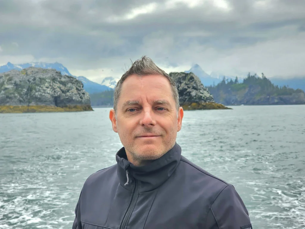 Cruising with Danny and Peter, Holland America Line, Westerdam, Spit (Homer), Alaska, United States | Boat on a morning water tour near Spit with Alaska Water Taxi & Charter, showing seabirds in flight, playful seals in Peterson Bay, sea otters in Cook Inlet, and guests enjoying The Orange Party on the Westerdam. Highlights include scenic boardwalk in Spit and a delicious Alaska seafood boil at Lido Market.