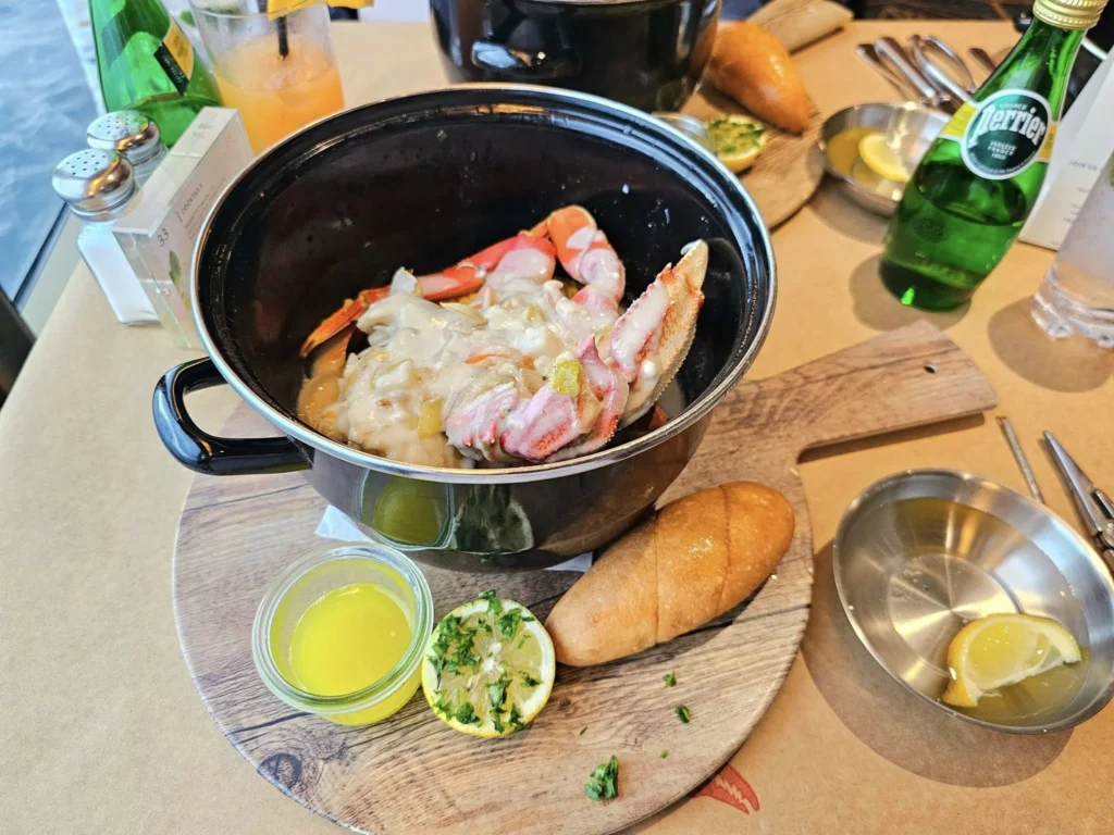 Cruising with Danny and Peter, Holland America Line, Westerdam, Spit (Homer), Alaska, United States | Boat on a morning water tour near Spit with Alaska Water Taxi & Charter, showing seabirds in flight, playful seals in Peterson Bay, sea otters in Cook Inlet, and guests enjoying The Orange Party on the Westerdam. Highlights include scenic boardwalk in Spit and a delicious Alaska seafood boil at Lido Market.