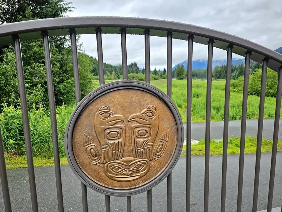Cruising with Danny and Peter, Holland America Line, Westerdam, Juneau, Alaska, United States | Boat approaching Sentinel Island Lighthouse during Alaska whale watching tour, with humpback whale and stunning coastal scenery in the background.