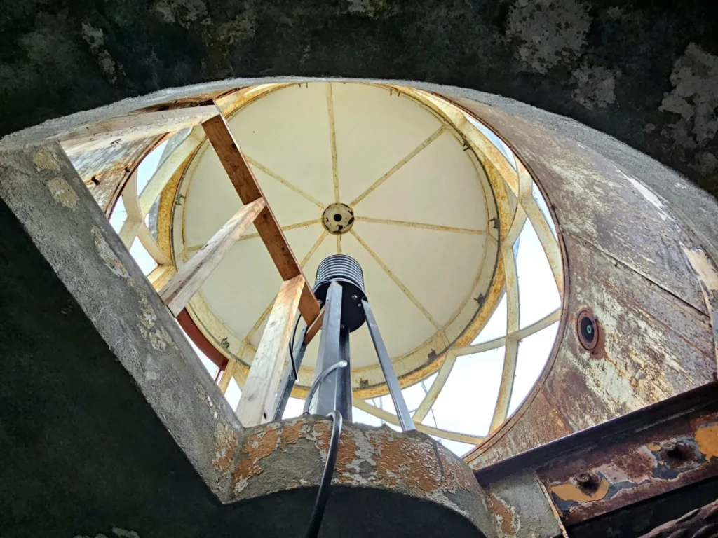 Cruising with Danny and Peter, Holland America Line, Westerdam, Juneau, Alaska, United States | Boat approaching Sentinel Island Lighthouse during Alaska whale watching tour, with humpback whale and stunning coastal scenery in the background.