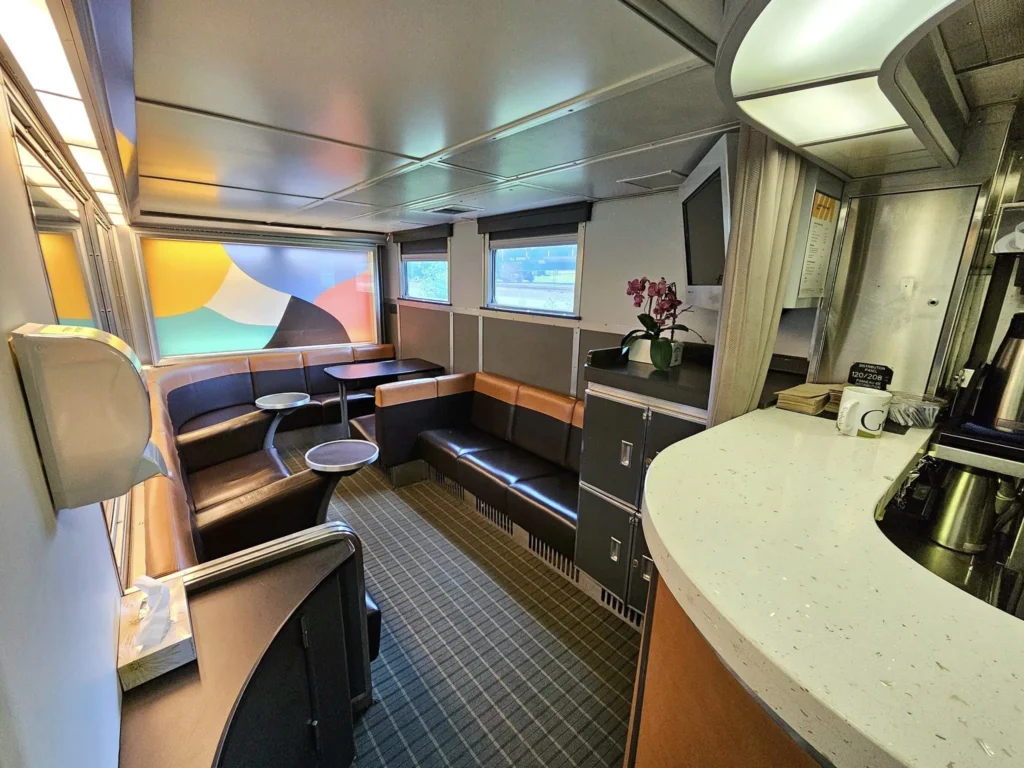 Cruising with Danny and Peter, Holland America Line, Westerdam, Prince Rupert, British Columbia, Canada | In the heart of British Columbia’s wild embrace, Where the Great Bear Rainforest weaves its mystic lace, A journey unfolds, both rail and road in stride, Through nature’s grandeur, where dreams and landscapes collide. From Prince Rupert’s charm, the train departs with grace, A serpentine path through forests’ ancient face, Panoramic windows frame a living, verdant dream, As the Skeena River’s flow whispers its serene theme. Mountains rise like giants, draped in emerald hues, While bald eagles soar, their shadows fleeting views, Black bears wander softly through the forest deep, And mountain goats on rugged cliffs silently leap. Kleanza Creek’s waterfalls cascade with a roar, Nature’s symphony on the rainforest’s floor, And Exchamsiks Park, a jewel of glacial light, Where shimmering pools reflect the day’s pure delight. From rail to road, the scenic drive unveils, A tapestry of mountains and verdant trails, Each turn a canvas painted with the wild’s own hand, A journey through a wonderland, vast and grand. Back in Prince Rupert, where history finds its place, The Museum’s treasures weave a cultural grace, Totem poles and masks tell tales of ancient lore, In this land where the past and present gently soar. Through the Great Bear Rainforest, we wandered wide, In rail and road’s embrace, where nature and culture collide, A journey of wonder, where memories are spun, In the heart of British Columbia, under the sun.