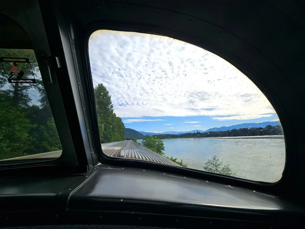 Cruising with Danny and Peter, Holland America Line, Westerdam, Prince Rupert, British Columbia, Canada | In the heart of British Columbia’s wild embrace, Where the Great Bear Rainforest weaves its mystic lace, A journey unfolds, both rail and road in stride, Through nature’s grandeur, where dreams and landscapes collide. From Prince Rupert’s charm, the train departs with grace, A serpentine path through forests’ ancient face, Panoramic windows frame a living, verdant dream, As the Skeena River’s flow whispers its serene theme. Mountains rise like giants, draped in emerald hues, While bald eagles soar, their shadows fleeting views, Black bears wander softly through the forest deep, And mountain goats on rugged cliffs silently leap. Kleanza Creek’s waterfalls cascade with a roar, Nature’s symphony on the rainforest’s floor, And Exchamsiks Park, a jewel of glacial light, Where shimmering pools reflect the day’s pure delight. From rail to road, the scenic drive unveils, A tapestry of mountains and verdant trails, Each turn a canvas painted with the wild’s own hand, A journey through a wonderland, vast and grand. Back in Prince Rupert, where history finds its place, The Museum’s treasures weave a cultural grace, Totem poles and masks tell tales of ancient lore, In this land where the past and present gently soar. Through the Great Bear Rainforest, we wandered wide, In rail and road’s embrace, where nature and culture collide, A journey of wonder, where memories are spun, In the heart of British Columbia, under the sun.