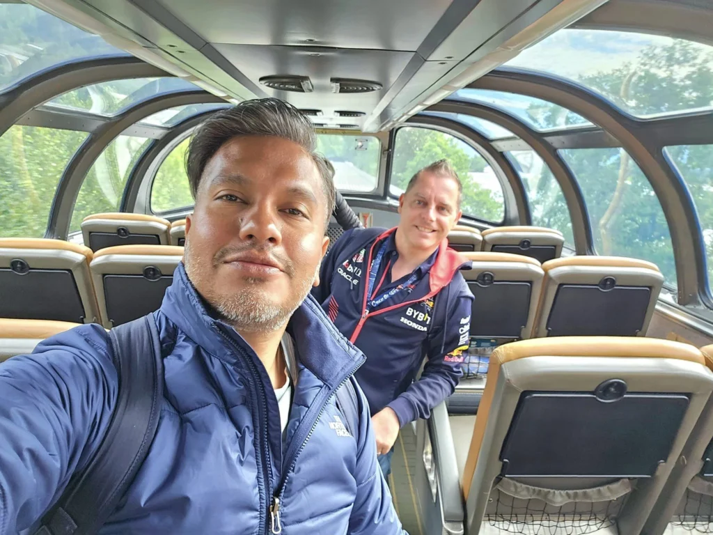 Cruising with Danny and Peter, Holland America Line, Westerdam, Prince Rupert, British Columbia, Canada | In the heart of British Columbia’s wild embrace, Where the Great Bear Rainforest weaves its mystic lace, A journey unfolds, both rail and road in stride, Through nature’s grandeur, where dreams and landscapes collide. From Prince Rupert’s charm, the train departs with grace, A serpentine path through forests’ ancient face, Panoramic windows frame a living, verdant dream, As the Skeena River’s flow whispers its serene theme. Mountains rise like giants, draped in emerald hues, While bald eagles soar, their shadows fleeting views, Black bears wander softly through the forest deep, And mountain goats on rugged cliffs silently leap. Kleanza Creek’s waterfalls cascade with a roar, Nature’s symphony on the rainforest’s floor, And Exchamsiks Park, a jewel of glacial light, Where shimmering pools reflect the day’s pure delight. From rail to road, the scenic drive unveils, A tapestry of mountains and verdant trails, Each turn a canvas painted with the wild’s own hand, A journey through a wonderland, vast and grand. Back in Prince Rupert, where history finds its place, The Museum’s treasures weave a cultural grace, Totem poles and masks tell tales of ancient lore, In this land where the past and present gently soar. Through the Great Bear Rainforest, we wandered wide, In rail and road’s embrace, where nature and culture collide, A journey of wonder, where memories are spun, In the heart of British Columbia, under the sun.