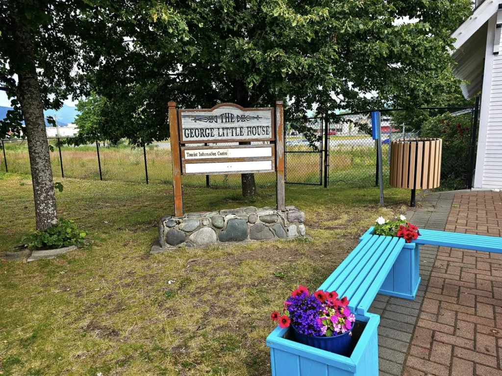 Cruising with Danny and Peter, Holland America Line, Westerdam, Prince Rupert, British Columbia, Canada | In the heart of British Columbia’s wild embrace, Where the Great Bear Rainforest weaves its mystic lace, A journey unfolds, both rail and road in stride, Through nature’s grandeur, where dreams and landscapes collide. From Prince Rupert’s charm, the train departs with grace, A serpentine path through forests’ ancient face, Panoramic windows frame a living, verdant dream, As the Skeena River’s flow whispers its serene theme. Mountains rise like giants, draped in emerald hues, While bald eagles soar, their shadows fleeting views, Black bears wander softly through the forest deep, And mountain goats on rugged cliffs silently leap. Kleanza Creek’s waterfalls cascade with a roar, Nature’s symphony on the rainforest’s floor, And Exchamsiks Park, a jewel of glacial light, Where shimmering pools reflect the day’s pure delight. From rail to road, the scenic drive unveils, A tapestry of mountains and verdant trails, Each turn a canvas painted with the wild’s own hand, A journey through a wonderland, vast and grand. Back in Prince Rupert, where history finds its place, The Museum’s treasures weave a cultural grace, Totem poles and masks tell tales of ancient lore, In this land where the past and present gently soar. Through the Great Bear Rainforest, we wandered wide, In rail and road’s embrace, where nature and culture collide, A journey of wonder, where memories are spun, In the heart of British Columbia, under the sun.