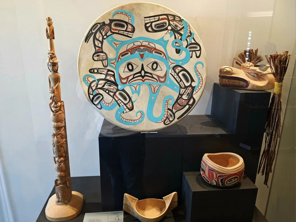 Cruising with Danny and Peter, Holland America Line, Westerdam, Prince Rupert, British Columbia, Canada | In the heart of British Columbia’s wild embrace, Where the Great Bear Rainforest weaves its mystic lace, A journey unfolds, both rail and road in stride, Through nature’s grandeur, where dreams and landscapes collide. From Prince Rupert’s charm, the train departs with grace, A serpentine path through forests’ ancient face, Panoramic windows frame a living, verdant dream, As the Skeena River’s flow whispers its serene theme. Mountains rise like giants, draped in emerald hues, While bald eagles soar, their shadows fleeting views, Black bears wander softly through the forest deep, And mountain goats on rugged cliffs silently leap. Kleanza Creek’s waterfalls cascade with a roar, Nature’s symphony on the rainforest’s floor, And Exchamsiks Park, a jewel of glacial light, Where shimmering pools reflect the day’s pure delight. From rail to road, the scenic drive unveils, A tapestry of mountains and verdant trails, Each turn a canvas painted with the wild’s own hand, A journey through a wonderland, vast and grand. Back in Prince Rupert, where history finds its place, The Museum’s treasures weave a cultural grace, Totem poles and masks tell tales of ancient lore, In this land where the past and present gently soar. Through the Great Bear Rainforest, we wandered wide, In rail and road’s embrace, where nature and culture collide, A journey of wonder, where memories are spun, In the heart of British Columbia, under the sun.