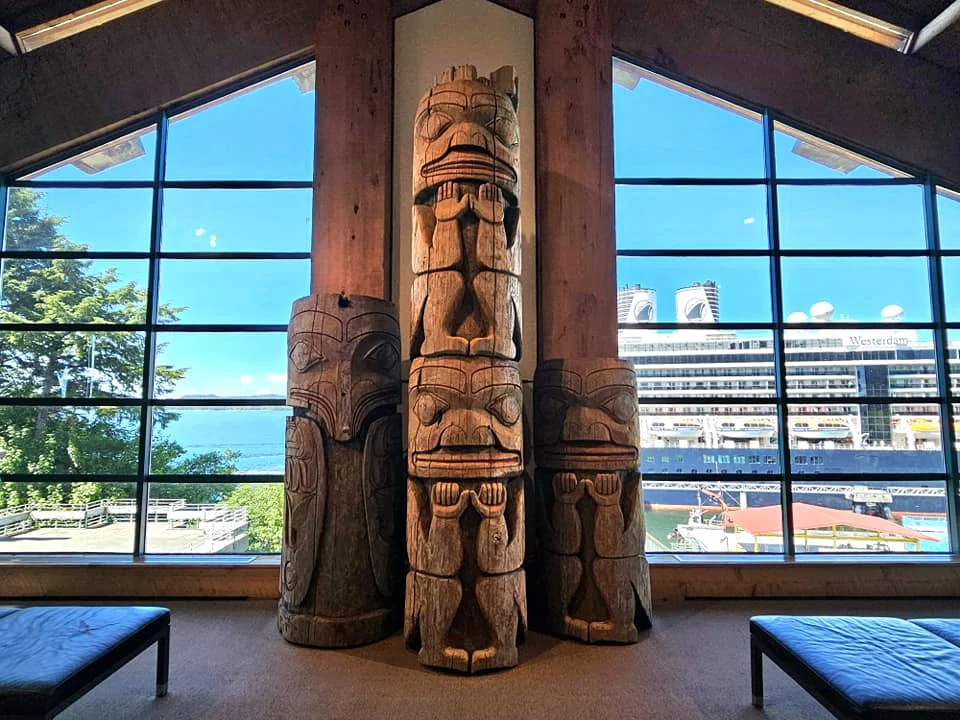 Cruising with Danny and Peter, Holland America Line, Westerdam, Prince Rupert, British Columbia, Canada | In the heart of British Columbia’s wild embrace, Where the Great Bear Rainforest weaves its mystic lace, A journey unfolds, both rail and road in stride, Through nature’s grandeur, where dreams and landscapes collide. From Prince Rupert’s charm, the train departs with grace, A serpentine path through forests’ ancient face, Panoramic windows frame a living, verdant dream, As the Skeena River’s flow whispers its serene theme. Mountains rise like giants, draped in emerald hues, While bald eagles soar, their shadows fleeting views, Black bears wander softly through the forest deep, And mountain goats on rugged cliffs silently leap. Kleanza Creek’s waterfalls cascade with a roar, Nature’s symphony on the rainforest’s floor, And Exchamsiks Park, a jewel of glacial light, Where shimmering pools reflect the day’s pure delight. From rail to road, the scenic drive unveils, A tapestry of mountains and verdant trails, Each turn a canvas painted with the wild’s own hand, A journey through a wonderland, vast and grand. Back in Prince Rupert, where history finds its place, The Museum’s treasures weave a cultural grace, Totem poles and masks tell tales of ancient lore, In this land where the past and present gently soar. Through the Great Bear Rainforest, we wandered wide, In rail and road’s embrace, where nature and culture collide, A journey of wonder, where memories are spun, In the heart of British Columbia, under the sun.