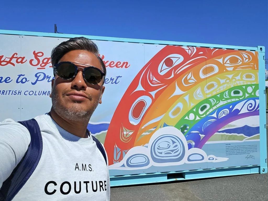 Cruising with Danny and Peter, Holland America Line, Westerdam, Prince Rupert, British Columbia, Canada | In the heart of British Columbia’s wild embrace, Where the Great Bear Rainforest weaves its mystic lace, A journey unfolds, both rail and road in stride, Through nature’s grandeur, where dreams and landscapes collide. From Prince Rupert’s charm, the train departs with grace, A serpentine path through forests’ ancient face, Panoramic windows frame a living, verdant dream, As the Skeena River’s flow whispers its serene theme. Mountains rise like giants, draped in emerald hues, While bald eagles soar, their shadows fleeting views, Black bears wander softly through the forest deep, And mountain goats on rugged cliffs silently leap. Kleanza Creek’s waterfalls cascade with a roar, Nature’s symphony on the rainforest’s floor, And Exchamsiks Park, a jewel of glacial light, Where shimmering pools reflect the day’s pure delight. From rail to road, the scenic drive unveils, A tapestry of mountains and verdant trails, Each turn a canvas painted with the wild’s own hand, A journey through a wonderland, vast and grand. Back in Prince Rupert, where history finds its place, The Museum’s treasures weave a cultural grace, Totem poles and masks tell tales of ancient lore, In this land where the past and present gently soar. Through the Great Bear Rainforest, we wandered wide, In rail and road’s embrace, where nature and culture collide, A journey of wonder, where memories are spun, In the heart of British Columbia, under the sun.