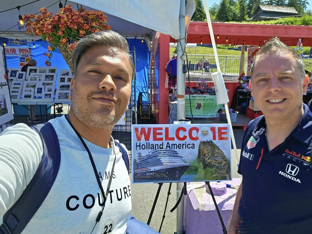 Cruising with Danny and Peter, Holland America Line, Westerdam, Prince Rupert, British Columbia, Canada | In the heart of British Columbia’s wild embrace, Where the Great Bear Rainforest weaves its mystic lace, A journey unfolds, both rail and road in stride, Through nature’s grandeur, where dreams and landscapes collide. From Prince Rupert’s charm, the train departs with grace, A serpentine path through forests’ ancient face, Panoramic windows frame a living, verdant dream, As the Skeena River’s flow whispers its serene theme. Mountains rise like giants, draped in emerald hues, While bald eagles soar, their shadows fleeting views, Black bears wander softly through the forest deep, And mountain goats on rugged cliffs silently leap. Kleanza Creek’s waterfalls cascade with a roar, Nature’s symphony on the rainforest’s floor, And Exchamsiks Park, a jewel of glacial light, Where shimmering pools reflect the day’s pure delight. From rail to road, the scenic drive unveils, A tapestry of mountains and verdant trails, Each turn a canvas painted with the wild’s own hand, A journey through a wonderland, vast and grand. Back in Prince Rupert, where history finds its place, The Museum’s treasures weave a cultural grace, Totem poles and masks tell tales of ancient lore, In this land where the past and present gently soar. Through the Great Bear Rainforest, we wandered wide, In rail and road’s embrace, where nature and culture collide, A journey of wonder, where memories are spun, In the heart of British Columbia, under the sun.