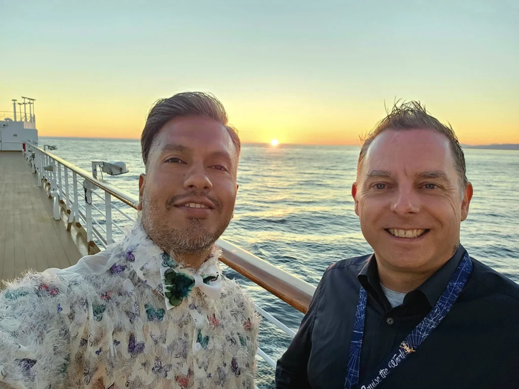 Cruising with Danny and Peter, Holland America Line, Westerdam, Seattle, Washington, United States | Stunning sunset over the ocean during a magical evening cruise from Prince Rupert on the Westerdam, with vibrant orange and pink skies reflecting on calm waters.