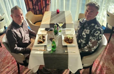 Cruising with Danny and Peter, Holland America Line, Westerdam, Seattle, Washington, United States | Stunning sunset over the ocean during a magical evening cruise from Prince Rupert on the Westerdam, with vibrant orange and pink skies reflecting on calm waters.