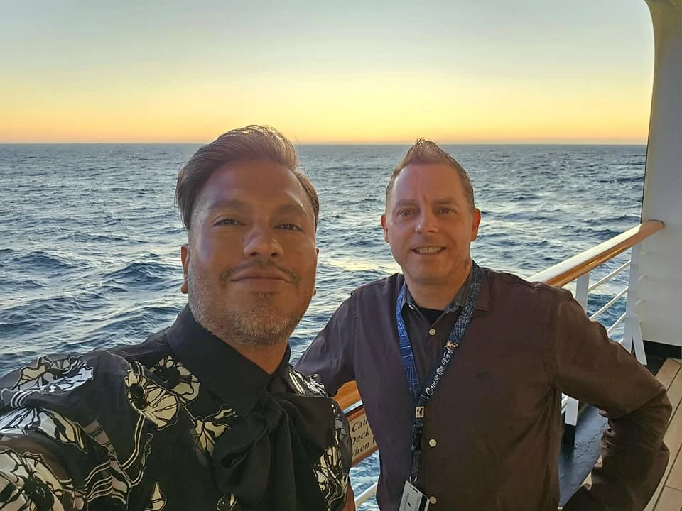 Cruising with Danny and Peter, Holland America Line, Westerdam, Seattle, Washington, United States | Stunning sunset over the ocean during a magical evening cruise from Prince Rupert on the Westerdam, with vibrant orange and pink skies reflecting on calm waters.