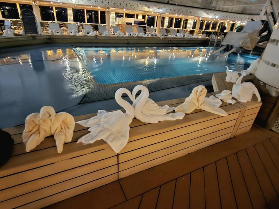 Cruising with Danny and Peter, Holland America Line, Westerdam, Seattle, Washington, United States | Stunning sunset over the ocean during a magical evening cruise from Prince Rupert on the Westerdam, with vibrant orange and pink skies reflecting on calm waters.