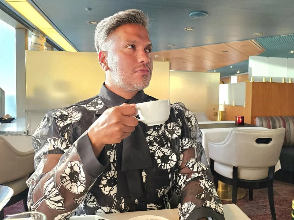 Cruising with Danny and Peter, Holland America Line, Westerdam, Seattle, Washington, United States | Stunning sunset over the ocean during a magical evening cruise from Prince Rupert on the Westerdam, with vibrant orange and pink skies reflecting on calm waters.