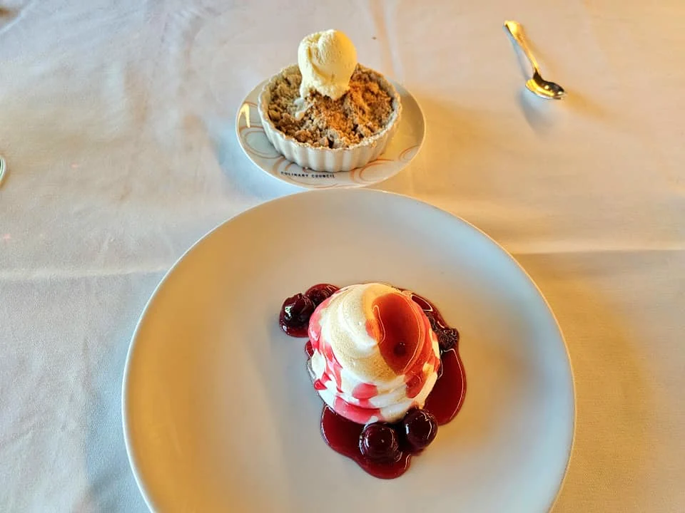 Cruising with Danny and Peter, Holland America Line, Westerdam, Seattle, Washington, United States | Stunning sunset over the ocean during a magical evening cruise from Prince Rupert on the Westerdam, with vibrant orange and pink skies reflecting on calm waters.