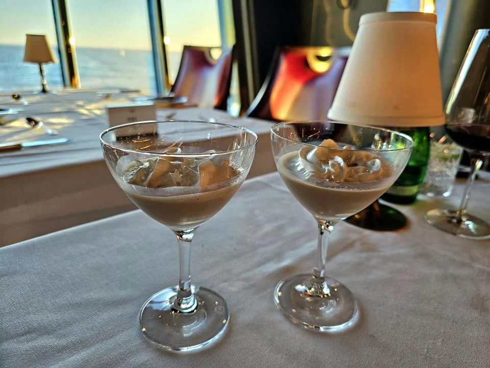 Cruising with Danny and Peter, Holland America Line, Westerdam, Seattle, Washington, United States | Stunning sunset over the ocean during a magical evening cruise from Prince Rupert on the Westerdam, with vibrant orange and pink skies reflecting on calm waters.