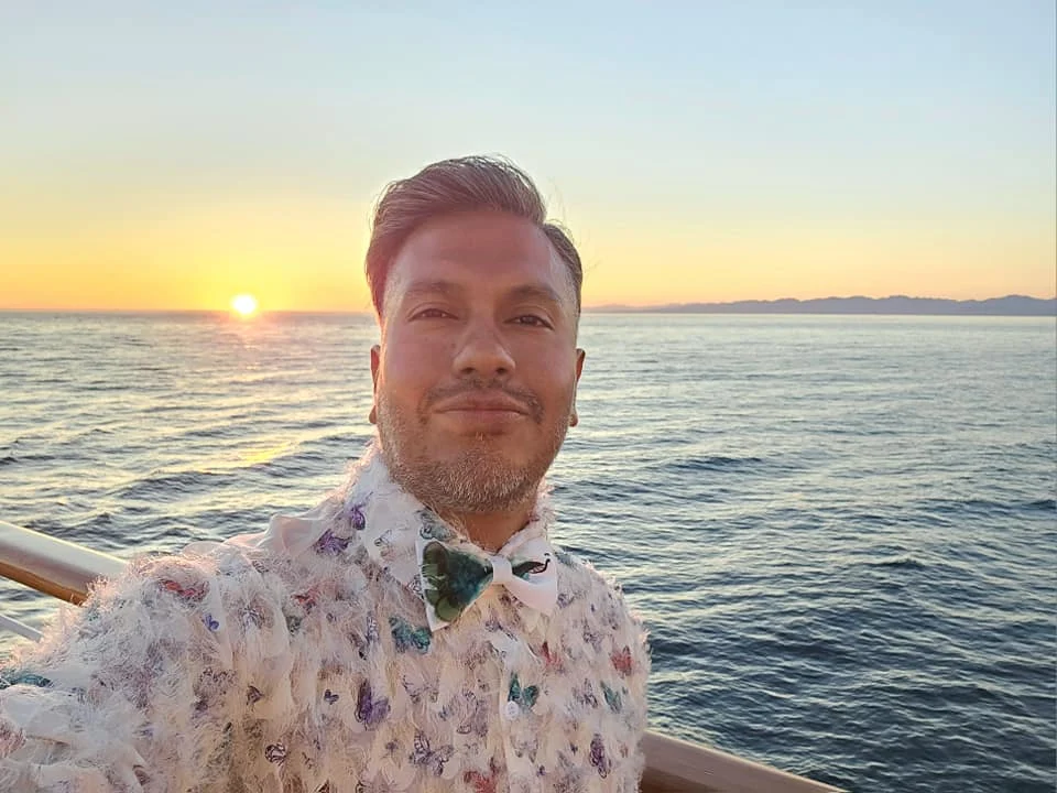 Cruising with Danny and Peter, Holland America Line, Westerdam, Seattle, Washington, United States | Stunning sunset over the ocean during a magical evening cruise from Prince Rupert on the Westerdam, with vibrant orange and pink skies reflecting on calm waters.