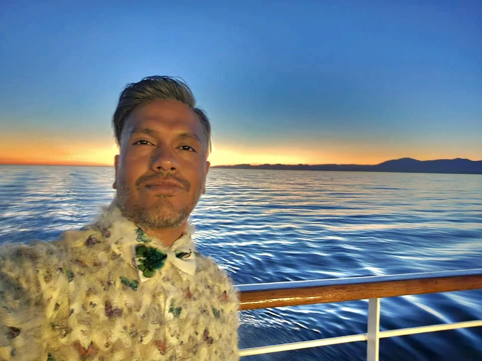 Cruising with Danny and Peter, Holland America Line, Westerdam, Seattle, Washington, United States | Stunning sunset over the ocean during a magical evening cruise from Prince Rupert on the Westerdam, with vibrant orange and pink skies reflecting on calm waters.