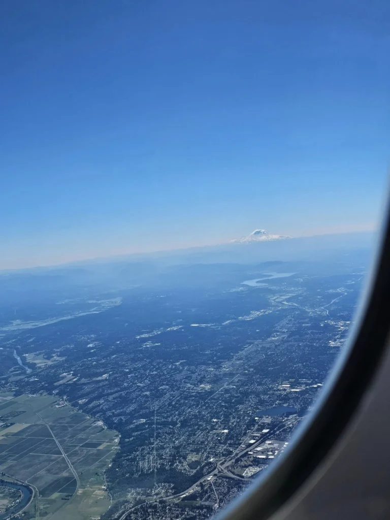 Cruising with Danny and Peter, Holland America Line, Westerdam, Seattle, Washington, United States | Aerial view of the MS Westerdam cruise ship sailing through Alaska’s stunning glaciers, showcasing the luxurious cruise experience and breathtaking scenery.