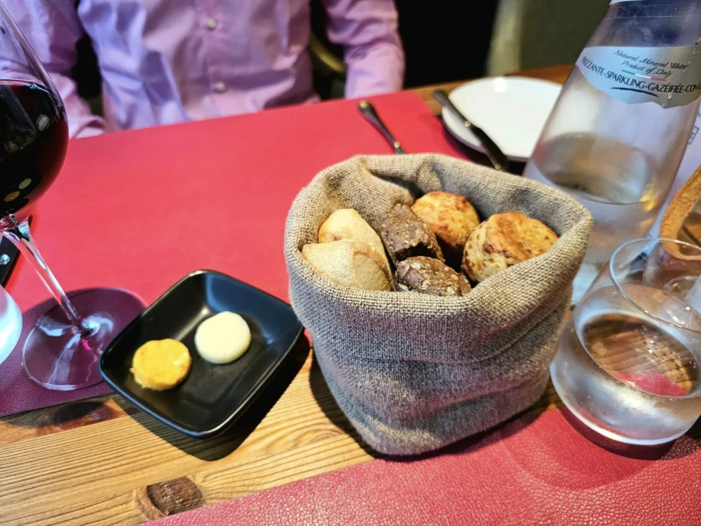 Cruising with Danny and Peter, MSC Cruises, MSC Preziosa, Rotterdam, The Netherlands, Birthday Cruise | The majestic MSC Preziosa cruise ship docked at Rotterdam’s Cruise Terminal on Wilhelminakade, its sleek white exterior gleaming against the modern city skyline with the iconic Erasmus Bridge in the background. Passengers board for a Northern Europe mini-cruise, celebrating a birthday with luxurious touches like a chilled bottle of Spumante and macarons in a stylish cabin. The vibrant onboard atmosphere features a gourmet dining experience at Butcher’s Cut Chef’s Table with a surprise birthday cake, thrilling entertainment at the Platinum Theater’s Rock Nation show with singers and dancers, and a lively Silent Disco in the Safari Lounge. The scene captures the excitement of embarkation day, with scenic views of Rotterdam’s waterfront, onboard shopping for MSC souvenirs, and the promise of an unforgettable luxury cruise vacation.