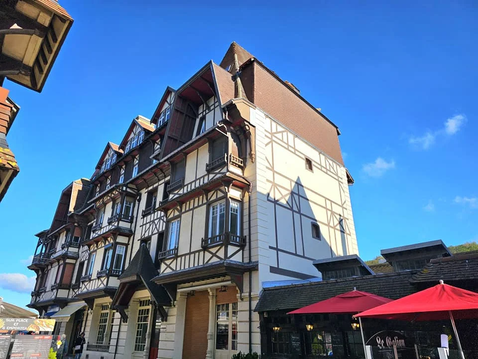 Cruising with Danny and Peter, MSC Cruises, MSC Preziosa, Le Havre, Paris, Étretat, France | Stunning views of the Étretat natural arches against the Normandy coastline, featuring the iconic L'Aiguille rock formation, picturesque half-timbered houses in Étretat, and travelers enjoying scenic walks along the cliffs during the unguided tour from MSC Preziosa.