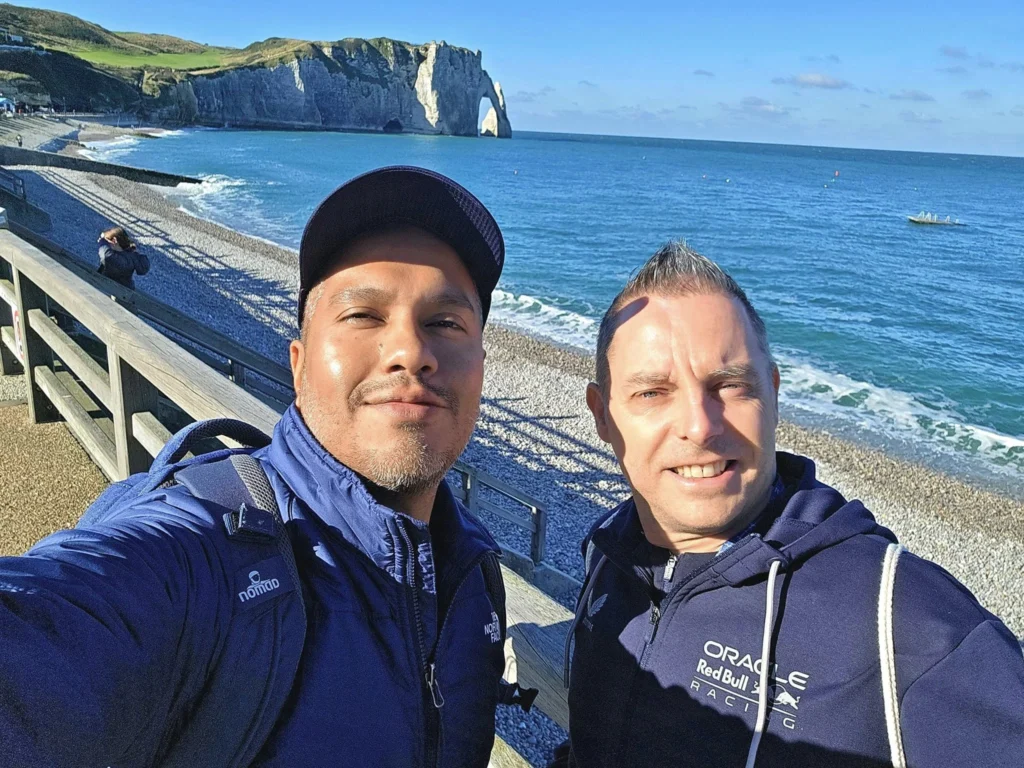 Cruising with Danny and Peter, MSC Cruises, MSC Preziosa, Le Havre, Paris, Étretat, France | Stunning views of the Étretat natural arches against the Normandy coastline, featuring the iconic L'Aiguille rock formation, picturesque half-timbered houses in Étretat, and travelers enjoying scenic walks along the cliffs during the unguided tour from MSC Preziosa.