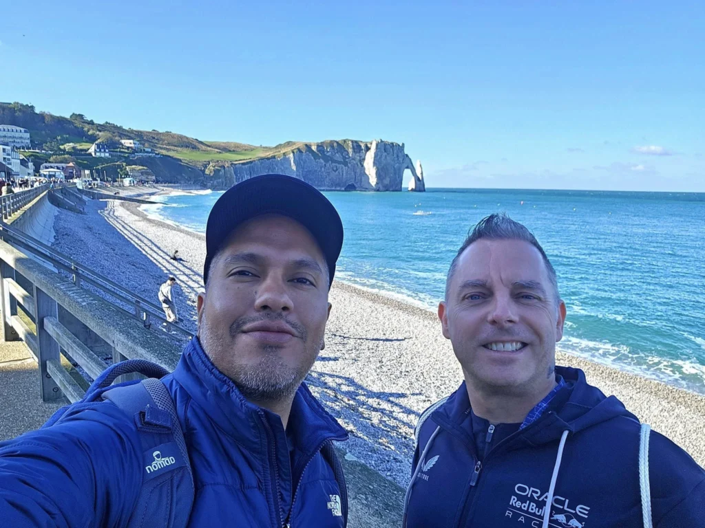 Cruising with Danny and Peter, MSC Cruises, MSC Preziosa, Le Havre, Paris, Étretat, France | Stunning views of the Étretat natural arches against the Normandy coastline, featuring the iconic L'Aiguille rock formation, picturesque half-timbered houses in Étretat, and travelers enjoying scenic walks along the cliffs during the unguided tour from MSC Preziosa.