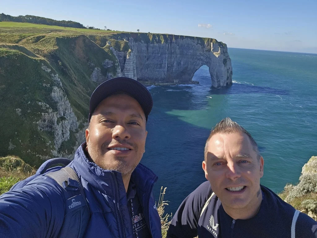 Cruising with Danny and Peter, MSC Cruises, MSC Preziosa, Le Havre, Paris, Étretat, France | Stunning views of the Étretat natural arches against the Normandy coastline, featuring the iconic L'Aiguille rock formation, picturesque half-timbered houses in Étretat, and travelers enjoying scenic walks along the cliffs during the unguided tour from MSC Preziosa.