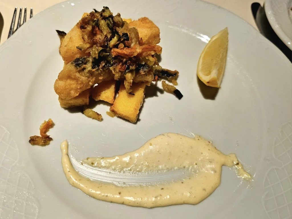 Cruising with Danny and Peter, MSC Cruises, MSC Preziosa, Le Havre, Paris, Étretat, France | Stunning views of the Étretat natural arches against the Normandy coastline, featuring the iconic L'Aiguille rock formation, picturesque half-timbered houses in Étretat, and travelers enjoying scenic walks along the cliffs during the unguided tour from MSC Preziosa.