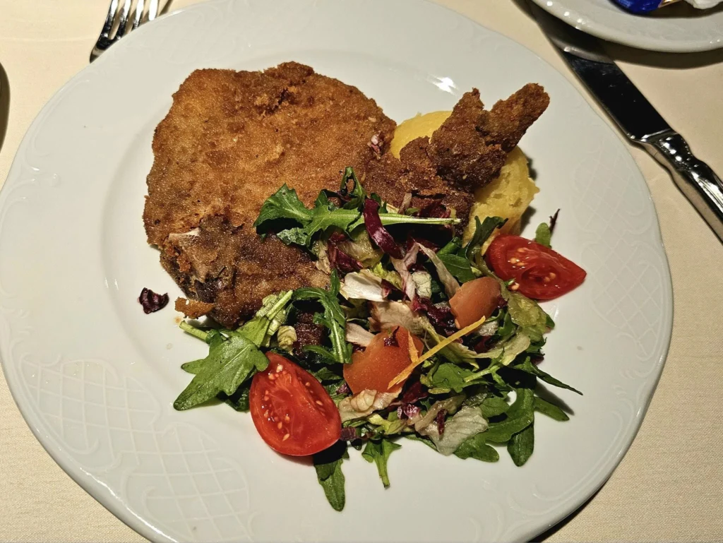 Cruising with Danny and Peter, MSC Cruises, MSC Preziosa, Le Havre, Paris, Étretat, France | Stunning views of the Étretat natural arches against the Normandy coastline, featuring the iconic L'Aiguille rock formation, picturesque half-timbered houses in Étretat, and travelers enjoying scenic walks along the cliffs during the unguided tour from MSC Preziosa.