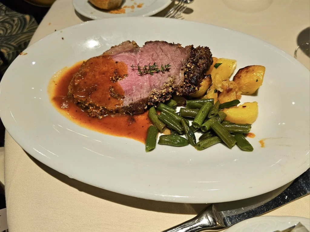 Cruising with Danny and Peter, MSC Cruises, MSC Preziosa, Le Havre, Paris, Étretat, France | Stunning views of the Étretat natural arches against the Normandy coastline, featuring the iconic L'Aiguille rock formation, picturesque half-timbered houses in Étretat, and travelers enjoying scenic walks along the cliffs during the unguided tour from MSC Preziosa.