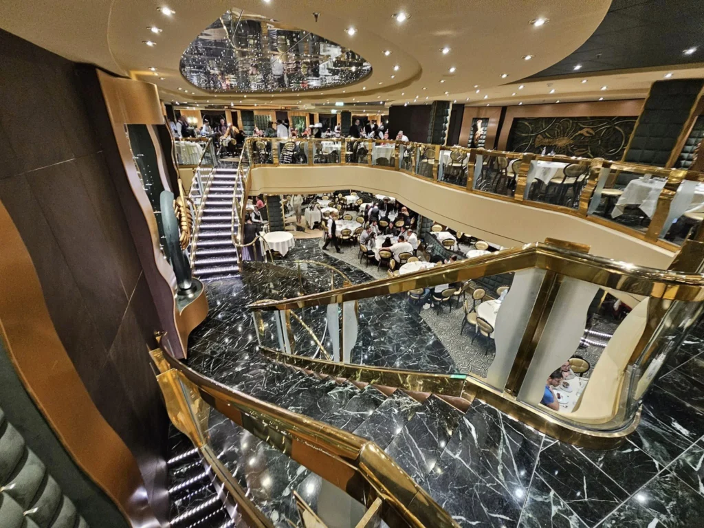 Cruising with Danny and Peter, MSC Cruises, MSC Preziosa, Le Havre, Paris, Étretat, France | Stunning views of the Étretat natural arches against the Normandy coastline, featuring the iconic L'Aiguille rock formation, picturesque half-timbered houses in Étretat, and travelers enjoying scenic walks along the cliffs during the unguided tour from MSC Preziosa.