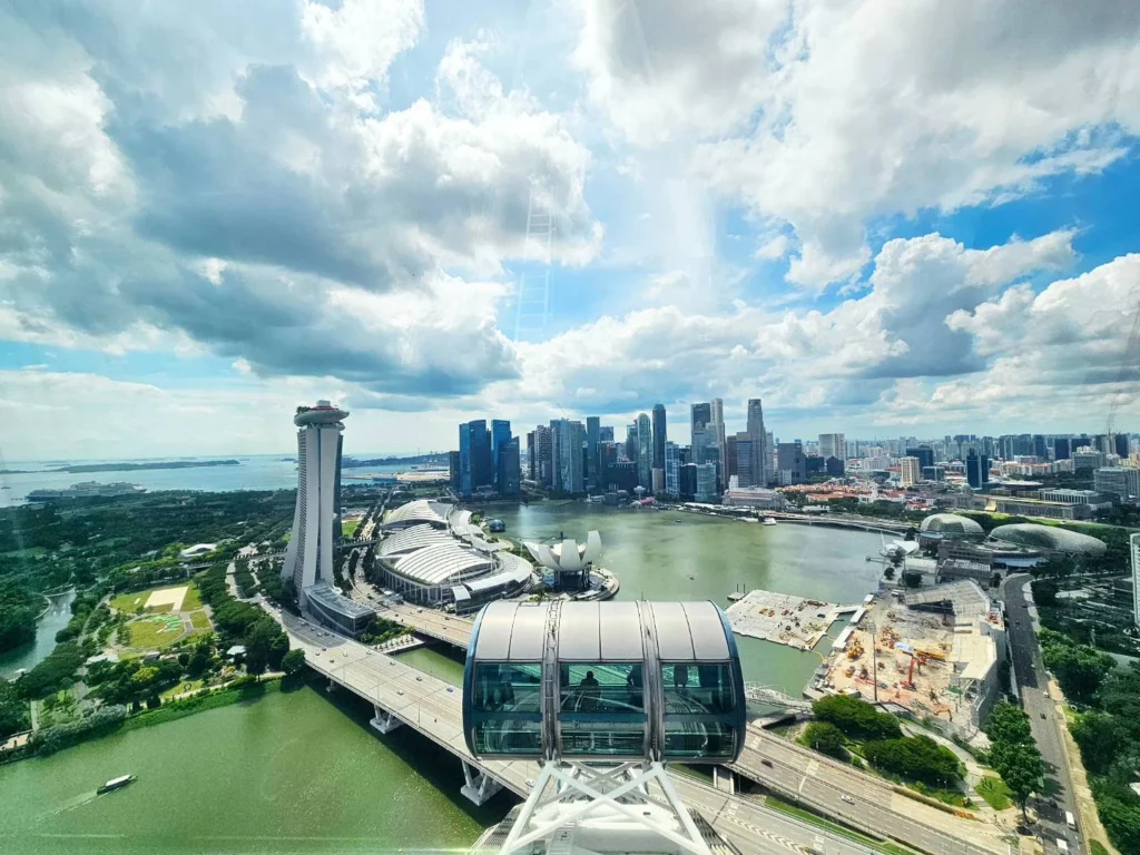 Cruising with Danny and Peter, Holland America Line, Westerdam, Singapore | View of Singapore's skyline from the Singapore Flyer during a spectacular adventure, showcasing iconic landmarks and vibrant cityscapes.