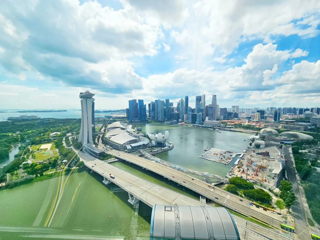 Cruising with Danny and Peter, Holland America Line, Westerdam, Singapore | View of Singapore's skyline from the Singapore Flyer during a spectacular adventure, showcasing iconic landmarks and vibrant cityscapes.