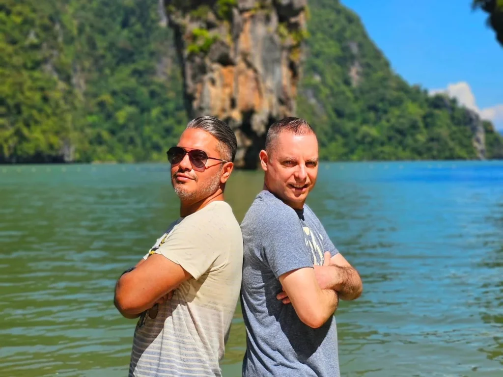 Cruising with Danny and Peter, Holland America Line, Westerdam, Phuket, Thailand | Longtail boat navigating clear waters near James Bond Island, showcasing iconic limestone cliffs. Enjoy dining at a floating restaurant on Phang Nga Bay, kayaking through lush mangroves, and exploring hidden caves with unique rock formations during an unforgettable Phuket island tour.
