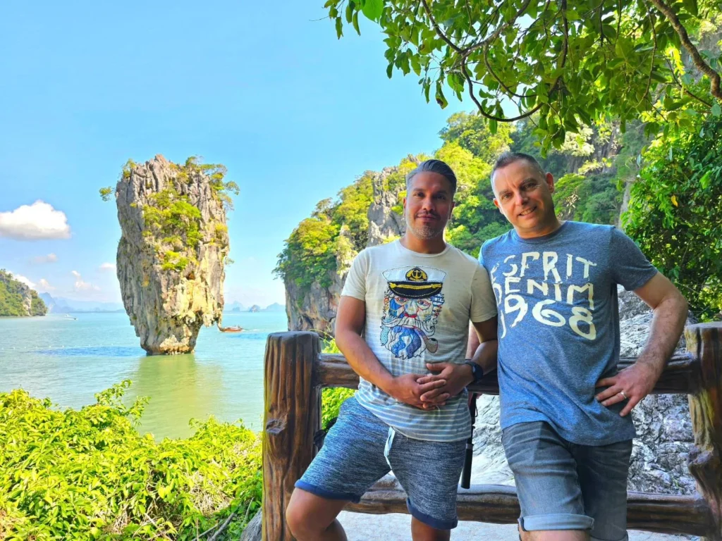 Cruising with Danny and Peter, Holland America Line, Westerdam, Phuket, Thailand | Longtail boat navigating clear waters near James Bond Island, showcasing iconic limestone cliffs. Enjoy dining at a floating restaurant on Phang Nga Bay, kayaking through lush mangroves, and exploring hidden caves with unique rock formations during an unforgettable Phuket island tour.