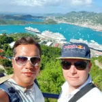 Cruising with Danny and Peter, Holland America Line, Zuiderdam, Charlotte Amalie, US Virgin Islands | A scenic view of a luxury catamaran sailing in the tranquil Caribbean waters near Charlotte Amalie, showcasing stunning landscapes of the U.S. Virgin Islands, vibrant marine life during snorkeling excursions, and secluded Caribbean beaches ideal for exploration.