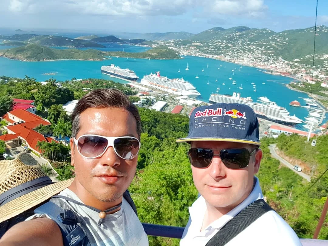 Cruising with Danny and Peter, Holland America Line, Zuiderdam, Charlotte Amalie, US Virgin Islands | A scenic view of a luxury catamaran sailing in the tranquil Caribbean waters near Charlotte Amalie, showcasing stunning landscapes of the U.S. Virgin Islands, vibrant marine life during snorkeling excursions, and secluded Caribbean beaches ideal for exploration.