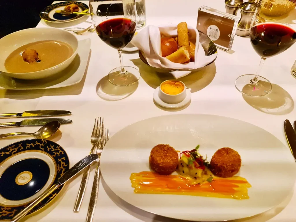 Cruising with Danny and Peter, Holland America Line, Koningsdam, Pacific Ocean, Sea Day | Guests enjoying a Hawaiian cruise experience, participating in cultural activities at sea, including lei-making, ukulele workshops, and hula dance lessons, surrounded by the beauty of the ocean and the spirit of Aloha.