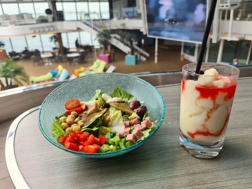 Cruising with Danny and Peter, Holland America Line, Koningsdam, Pacific Ocean, Sea Day | Guests enjoying a Hawaiian cruise experience, participating in cultural activities at sea, including lei-making, ukulele workshops, and hula dance lessons, surrounded by the beauty of the ocean and the spirit of Aloha.