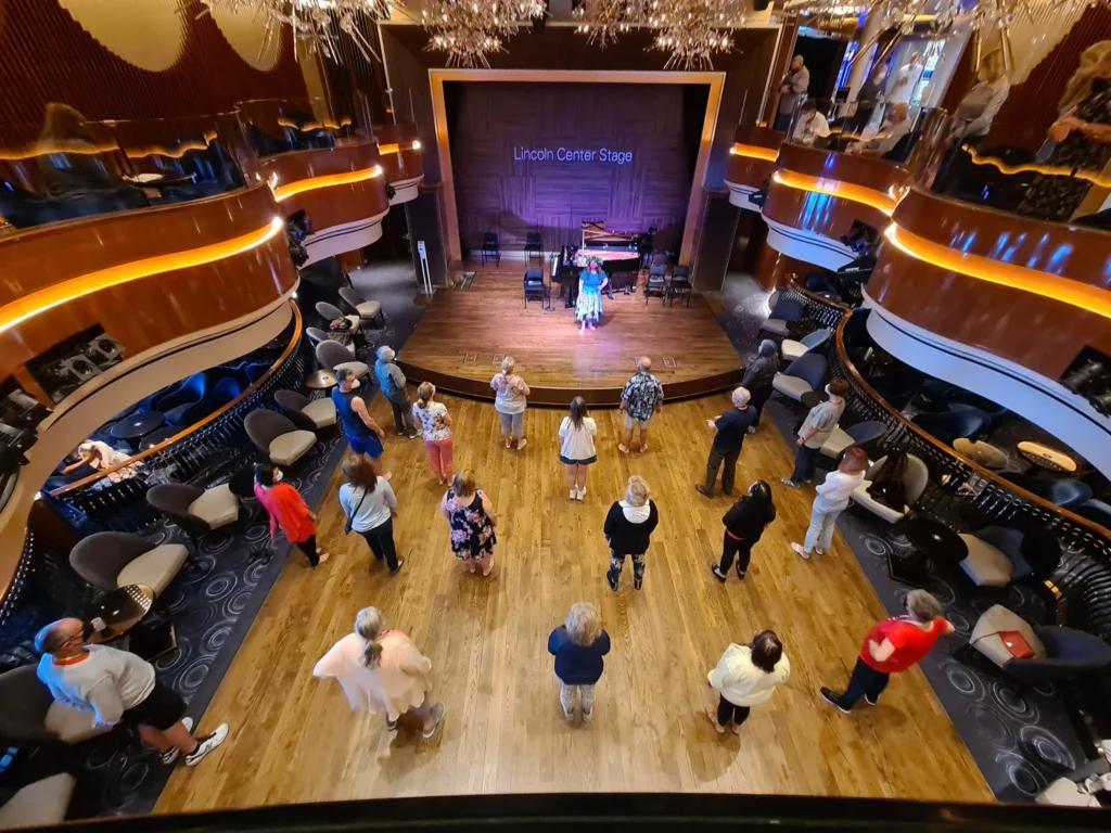 Cruising with Danny and Peter, Holland America Line, Koningsdam, Pacific Ocean, Sea Day | Guests enjoying a Hawaiian cruise experience, participating in cultural activities at sea, including lei-making, ukulele workshops, and hula dance lessons, surrounded by the beauty of the ocean and the spirit of Aloha.