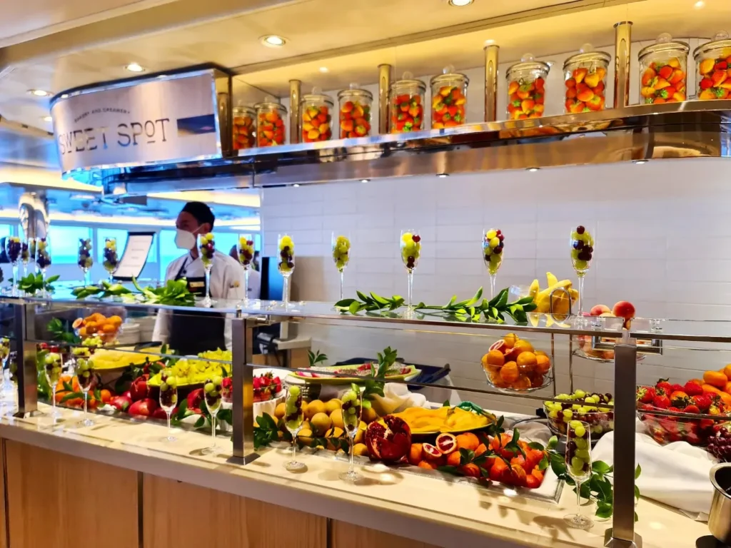 Cruising with Danny and Peter, Holland America Line, Koningsdam, Pacific Ocean, Sea Day | Passengers enjoying a tranquil Holland America sea day aboard a luxury cruise ship, participating in ocean voyage activities such as ukulele lessons, savoring gourmet dining at sea, and relaxing by the pool while overlooking the serene waters. The elegant ship provides panoramic ocean views and a perfect setting for a memorable Holland America Line experience. The day also includes presentations on maritime history, reflecting the ultimate luxury travel experience at sea.