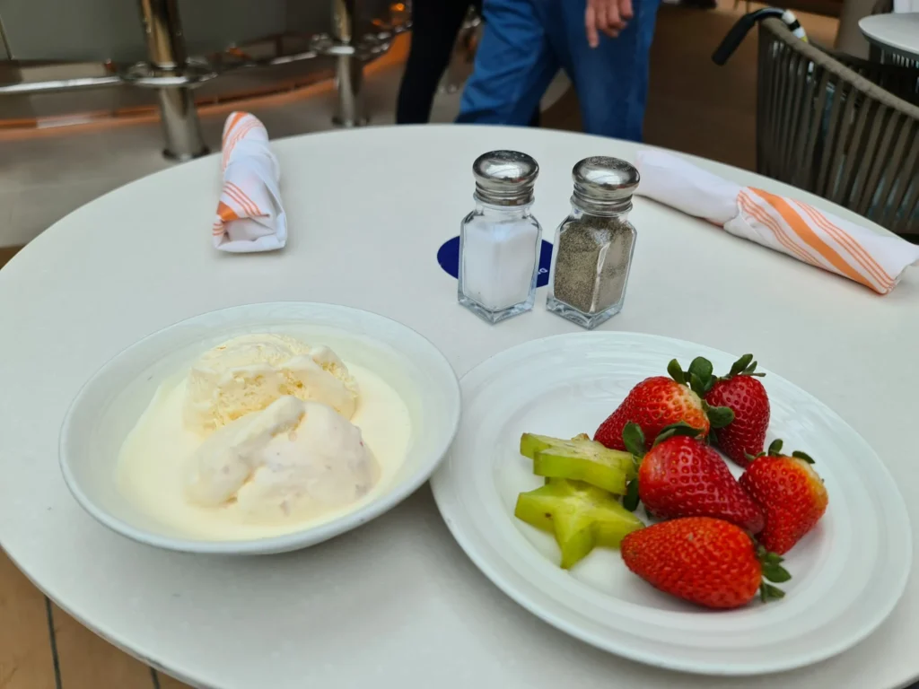 Cruising with Danny and Peter, Holland America Line, Koningsdam, Pacific Ocean, Sea Day | Passengers enjoying a tranquil Holland America sea day aboard a luxury cruise ship, participating in ocean voyage activities such as ukulele lessons, savoring gourmet dining at sea, and relaxing by the pool while overlooking the serene waters. The elegant ship provides panoramic ocean views and a perfect setting for a memorable Holland America Line experience. The day also includes presentations on maritime history, reflecting the ultimate luxury travel experience at sea.