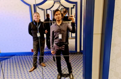 Cruising with Danny and Peter, Holland America Line, Koningsdam, Pacific Ocean, Sea Day | Passengers enjoying a tranquil Holland America sea day aboard a luxury cruise ship, participating in ocean voyage activities such as ukulele lessons, savoring gourmet dining at sea, and relaxing by the pool while overlooking the serene waters. The elegant ship provides panoramic ocean views and a perfect setting for a memorable Holland America Line experience. The day also includes presentations on maritime history, reflecting the ultimate luxury travel experience at sea.