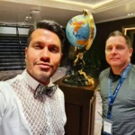 Cruising with Danny and Peter, Holland America Line, Koningsdam, Pacific Ocean, Sea Day | A breathtaking view of the ocean during a Relaxing Cruise Day at Sea Adventure, showcasing scenic ocean views and the cruise ship gliding over the waves. Guests enjoy onboard activities, sipping cocktails by the poolside, and indulging in a gourmet cruise ship dining experience in the elegant dining room, surrounded by a vibrant atmosphere and happy passengers. The sun sets in the background, adding warmth to the leisure at sea.