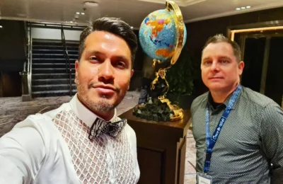 Cruising with Danny and Peter, Holland America Line, Koningsdam, Pacific Ocean, Sea Day | A breathtaking view of the ocean during a Relaxing Cruise Day at Sea Adventure, showcasing scenic ocean views and the cruise ship gliding over the waves. Guests enjoy onboard activities, sipping cocktails by the poolside, and indulging in a gourmet cruise ship dining experience in the elegant dining room, surrounded by a vibrant atmosphere and happy passengers. The sun sets in the background, adding warmth to the leisure at sea.